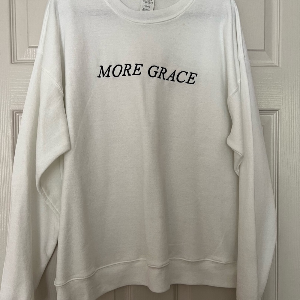 White Sweatshirt with 'More Grace' Text